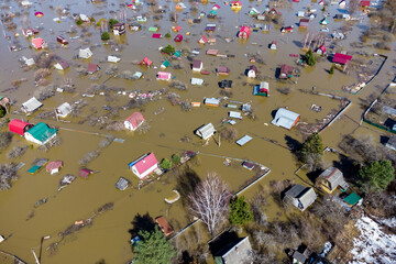 Private sector with small country houses flooded during the spring flood, flooding in rural areas from the air