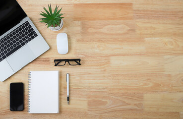 banner / with a stylish workspace with laptop computer, smartphone modern office accessories and on a blush table, top view