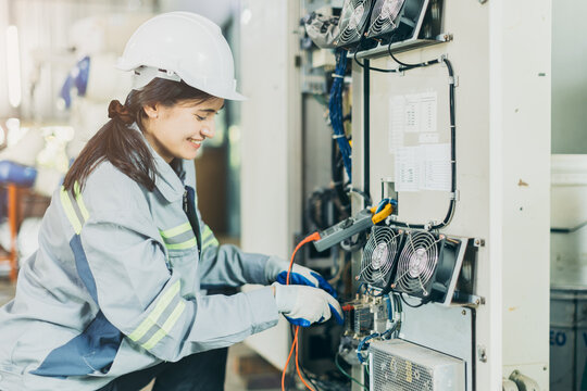 Electrician women worker checking repair maintenance fix service electric system. female electrician engineer setup testing electric cable at main power line.