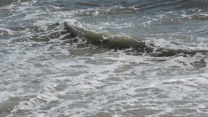 The wave foam on the beach