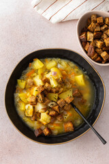 Pea soup with fried croutons, healthy bean soup, top view