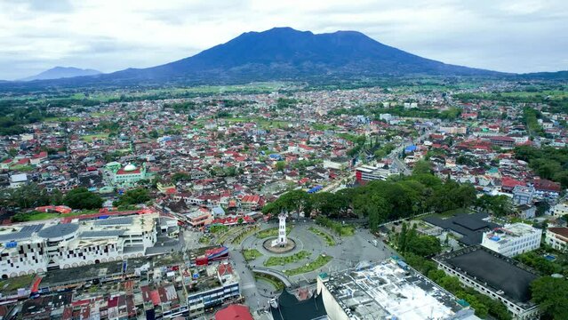 Establish aerial view of Big Clock Jam Gadang Bukittinggi, Revealing Surrounding | A clock tower, major landmark, and tourist attraction in the city of Bukittinggi, West Sumatra, Indonesia