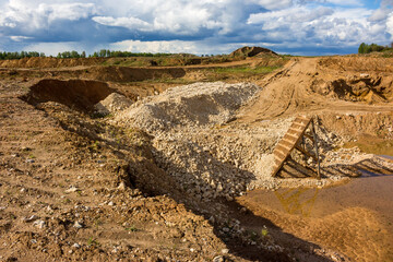 A small quarry for the extraction of gravel and crushed stone with a grid for sifting various...