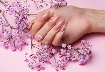 Obraz na płótnie Canvas Female hands with beautiful manicure on pink background