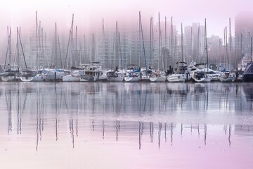 Boats in fog against city skyline. Coal Harbour Vancouver BC Canada 