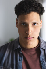 Obraz premium Portrait of serious biracial man in living room at home, copy space