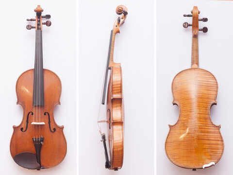 Antique fine violin from front, back and side on white background
