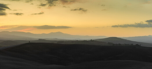 panorama landscape of rolling hills in Tuscany at sunrise
