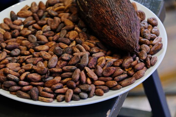 The fruit of the cocoa tree on a plate with grains.