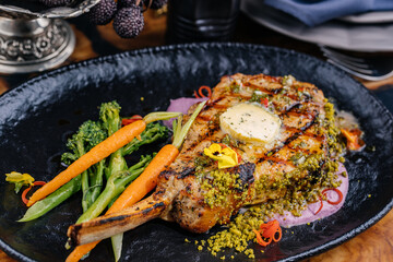 Charcoal grilled Pistachio Crusted Prime Veal Chops served in dish isolated on table top view of...