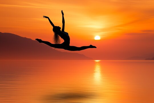 A breathtaking silhouette of a female dancer performing a leap against the backdrop of a vivid orange sunset over a calm sea. The scene is a blend of tranquility and dynamic movement, capturing the