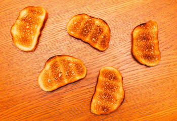 Bread fried in a toaster on a wooden table