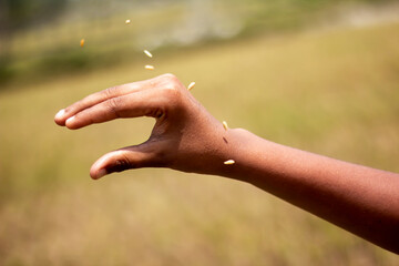 A man points his hand forward and the background is blurred