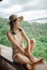 Carefree happy woman in morning of nature cliff mountain. Woman travel tourist alone morning freedom and happiness