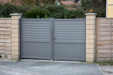 sliding gray gate double door steel big grey metal portal fence on modern house street