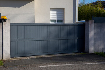 Fototapeta na wymiar portal sliding modern grey gate gliding steel entrance door slide gray property house