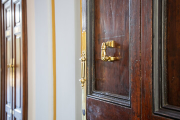 vintage golden old steel door knocker on wooden classic gate open