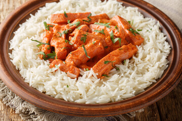 Korvstroganoff is the Swedish version of a dish known as beef Stroganoff prepared with a Swedish sausage falukorv with a side dish of rice closeup on the plate on the table. Horizontal