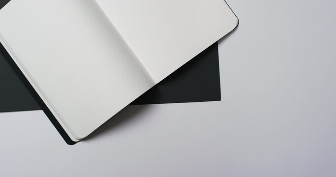 Video of book with white blank pages and copy space on black and white background