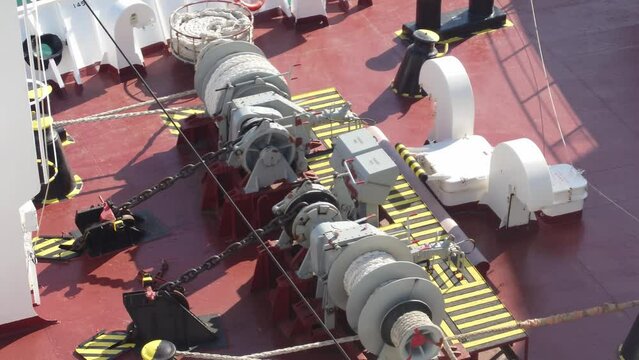 Reveal, pulleys, hoists and lots of shipping equipment on deck of vessel