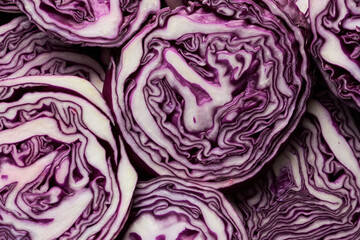 Top view background of red cabbage slices on black in abstract pattern