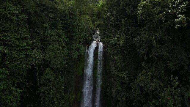 Close up to a wide view of Gitgit waterfall in the north of Bali, Indonesia. Aerial.