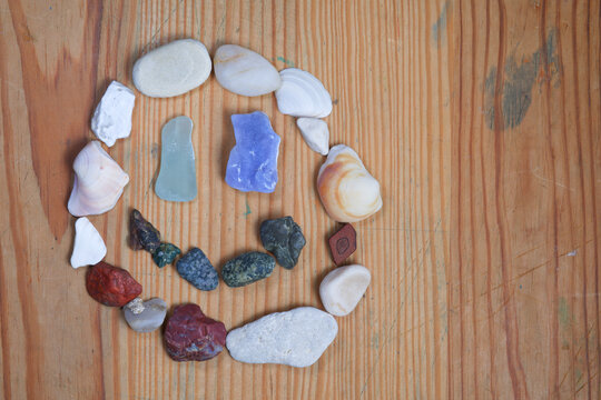 Colorful stones smiley face on a wooden background. 