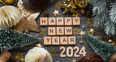 A postcard or banner. A symbol from the number 2024 with paper Christmas tree toys, stars, sequins and a beautiful bokeh on a wooden background. Happy New Year 2024. The concept of the celebration.