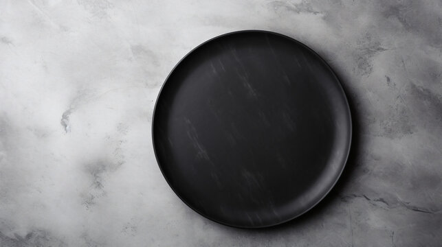 Black plate on white stone table