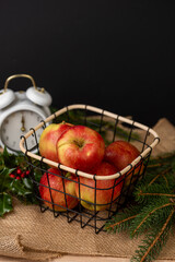 Apples in a metal basket, juicy fruits on the background, fresh and tasty