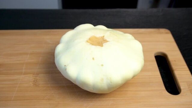 Patisson lies on a cutting board. Cooking master class. Preparing to cook a squash dish.