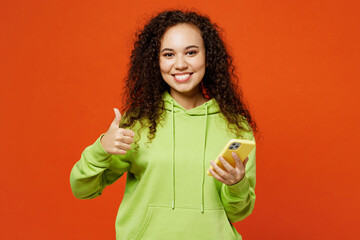 Young happy woman of African American ethnicity she wears green hoody casual clothes hold in hand...