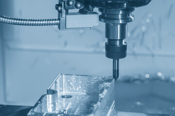 The CNC milling machine chamfer cutting mold base part by chamfer tool in the light blue scene.