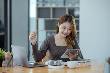 young asian woman and online education at desk.