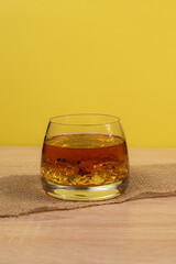 glass of whiskey with ice on a wooden background, exclusive alcoholic drink