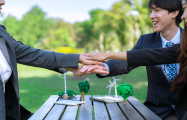 Business people join hand together as teamwork and unity, outdoor business meeting table....