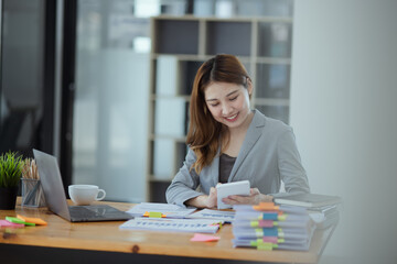 Asian Accounting Woman Working at Desk In Office. Business Financial and Accounting concept.