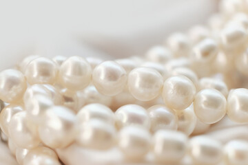 The whimsical placement of pearls on a white cloth depicts a serene, dreamy scenario. It's an...