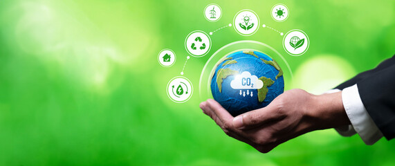 Businessman's hand holding Earth globe symbolize corporate commitment to ESG or CSR to reduce...