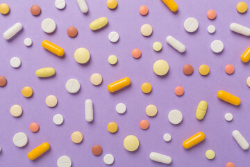 Flat lay with different medical pills and capsules on color background