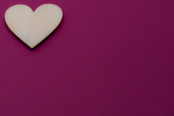 small wooden heart on purple background,saint valentine's day,valentine's day background,purple background with heart