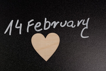 Background with the inscription February 14 and a wood heart, background for Valentine's Day