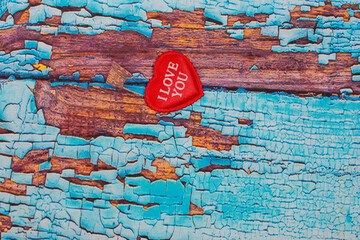 red heart with word love on wooden blue background 