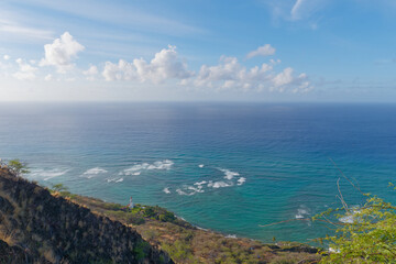 Fototapeta na wymiar Peaceful view of the sky, ocean, and Diamond Head Lighthouse in the distance from the Diamond Head hike, Oahu, Hawaii