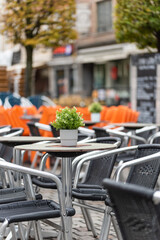 Outdoor empty coffee and restaurant terrace with potted plants tables and chairs 