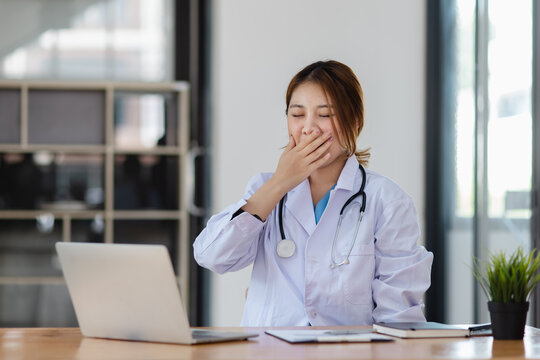 Asian female doctors face heavy levels of stress too with stethoscope sitting at desk in hospital, Medicine and healthcare concept.