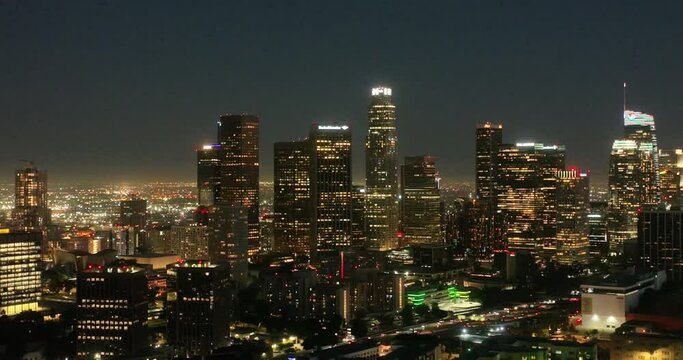Night aerial view of downtown Los Angeles, California. Downtown Los Angeles at night from drone. Night illuminated flight over Los Angeles city downtown panorama. Los Angeles night buildings skyline.