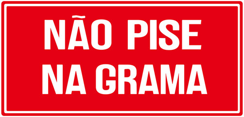 A sign in red color that says in Portuguese language : do not step on the grass or don't walk on the grass