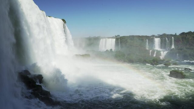 The Iguazu Falls are located at the border between Brazil and Argentina and are one of the seven wonders of the world, a popular ravel destination in the rainforest of south America.