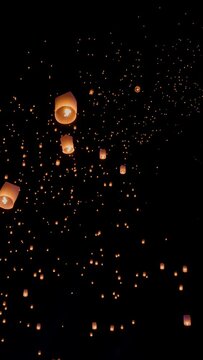 Tourist floating sky lanterns in Yi-Peng (Loy Krathong) festival , Chiang Mai ,Thailand. Vertical video.